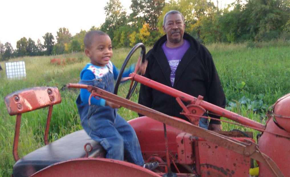 Jelani smiling on the tractor