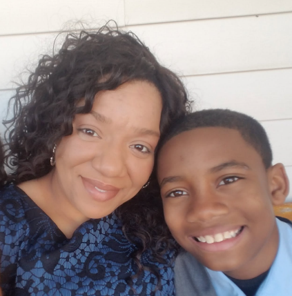 Jelani and his mother smiling together