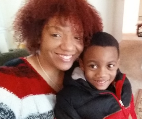 Jelani smiling beside a loved one