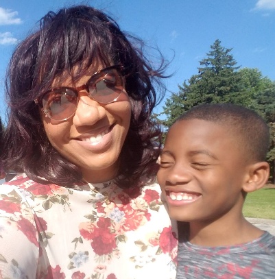 Jelani laughing with a loved one outdoors