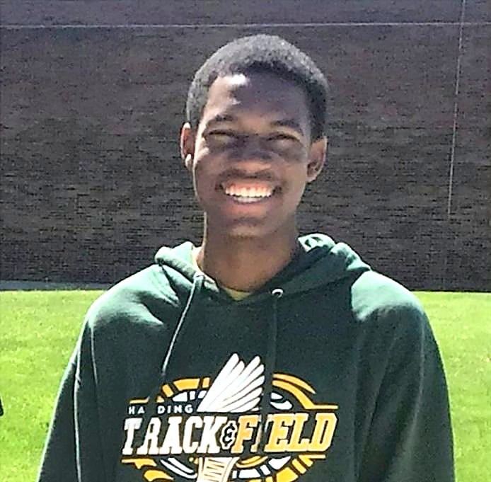 Jelani smiling in his Harding Track and Field hoodie