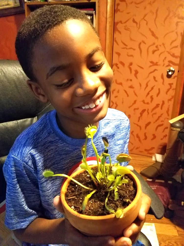 Jelani proudly holding his Venus flytrap