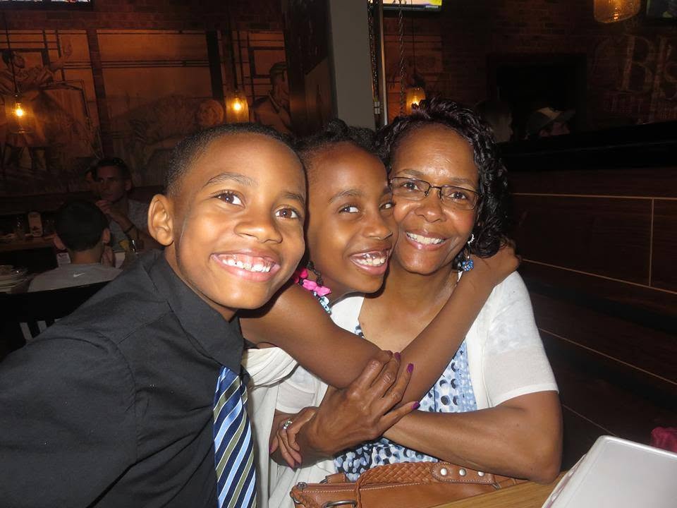 Jelani and Azaria smiling with their nana Sandra