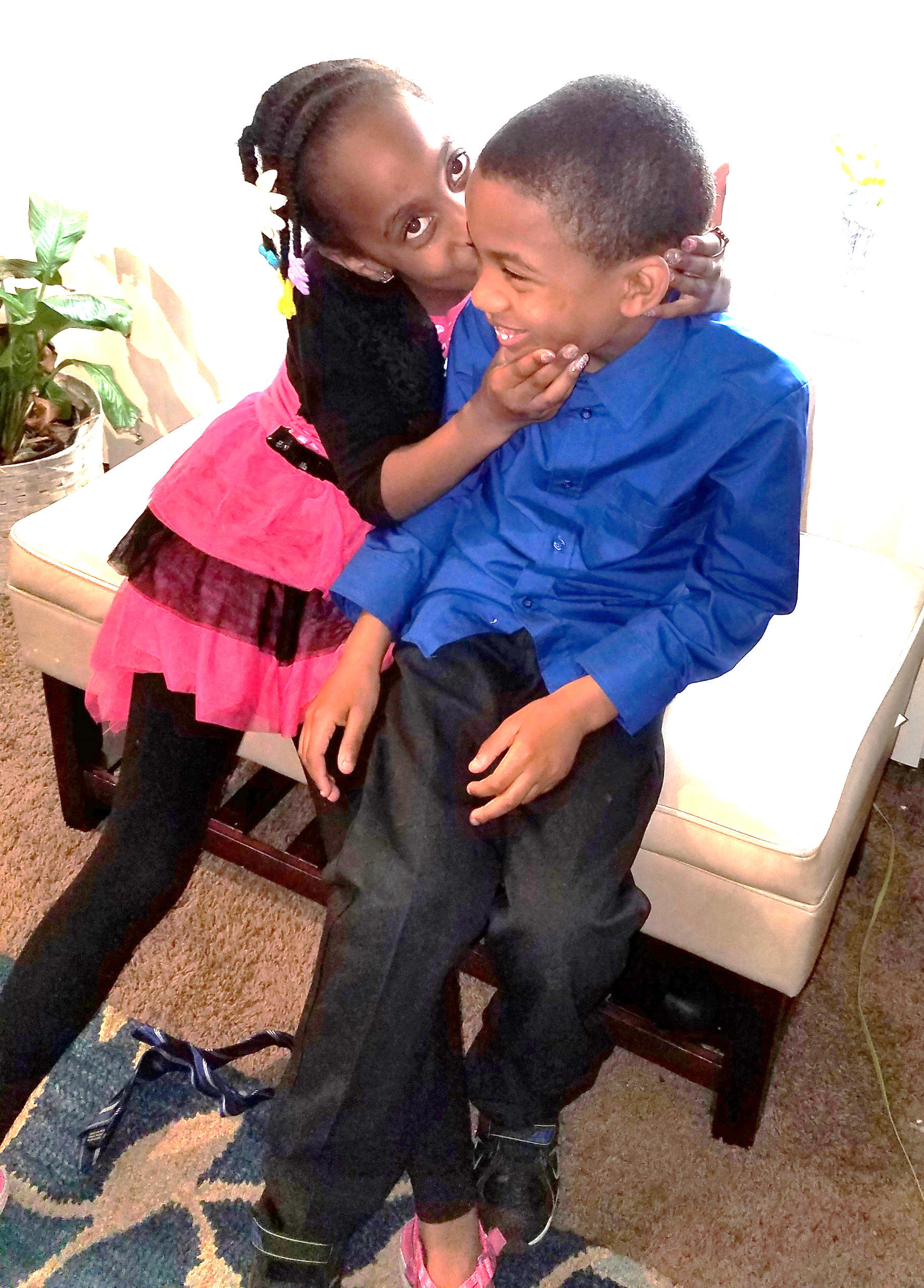 Azaria kissing Jelani on the cheek