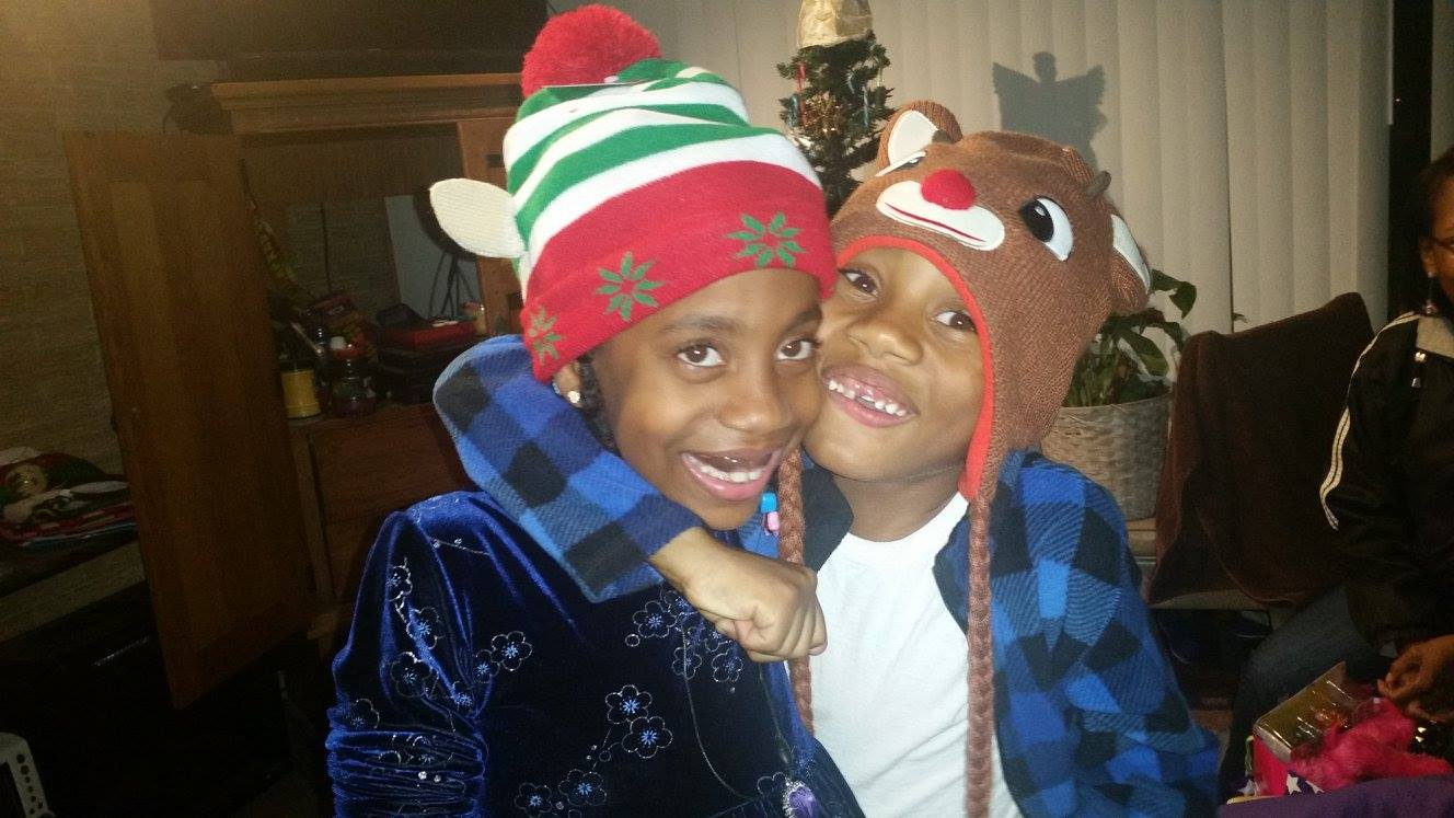Jelani and Azaria wearing festive hats