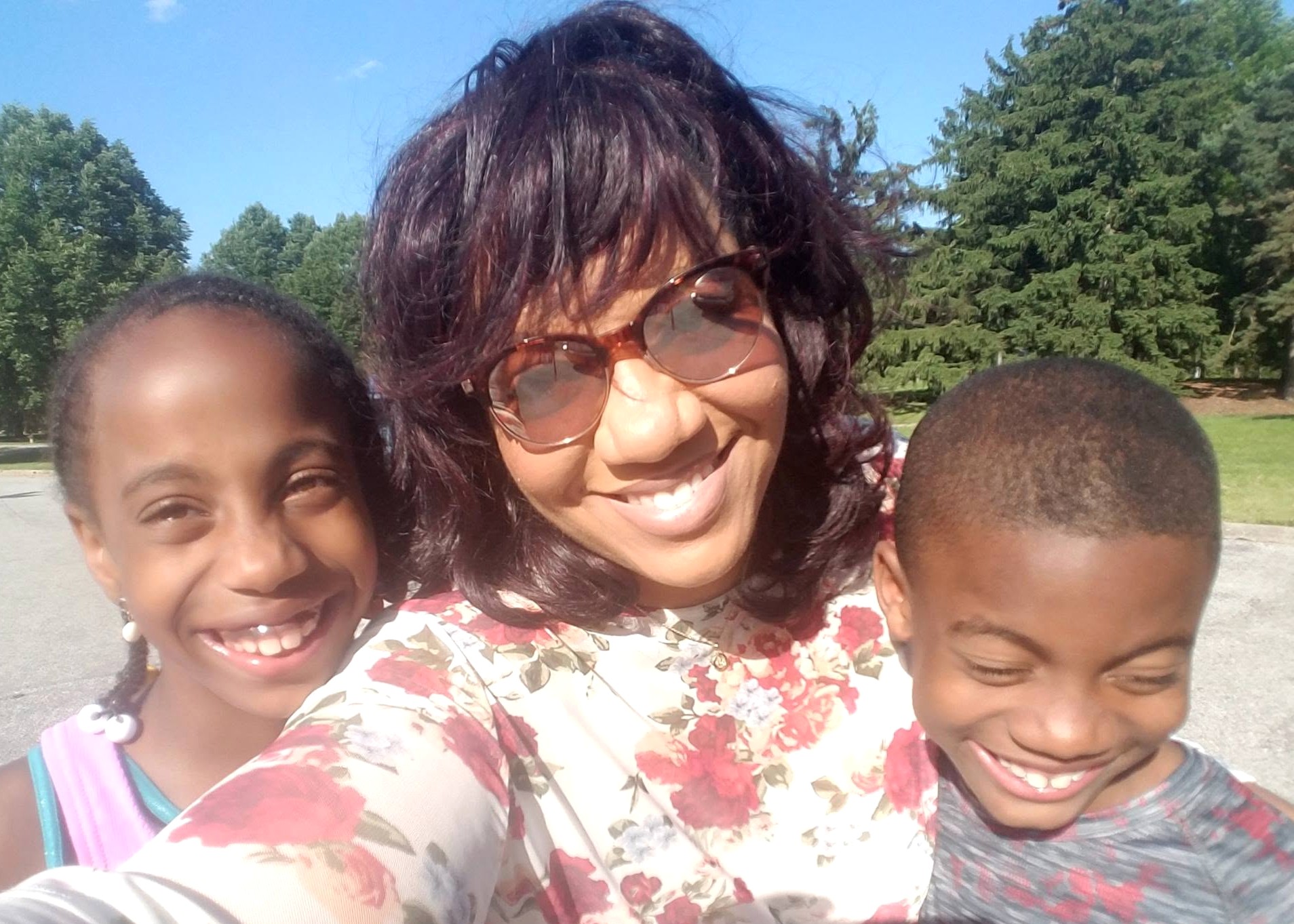 Tanisha with Jelani and Azaria smiling together outdoors